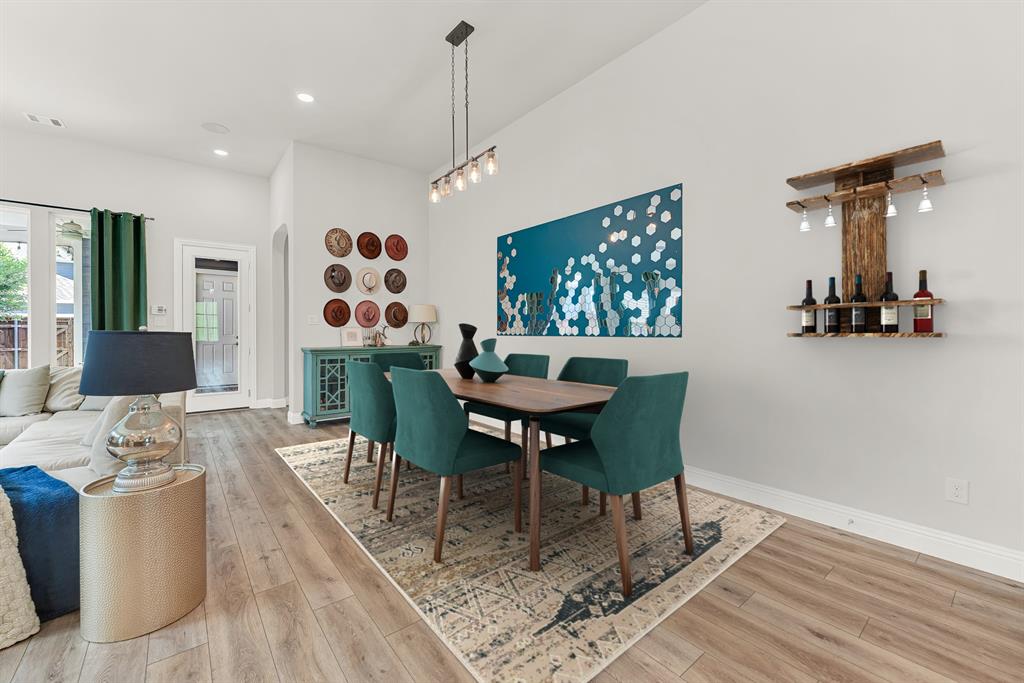 6404 Trezevant Street Rowlett, TX 75089 - Photo 14 of 30 a view of a dining room with furniture a rug and wooden floor