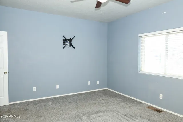 an empty room and closet area with a window