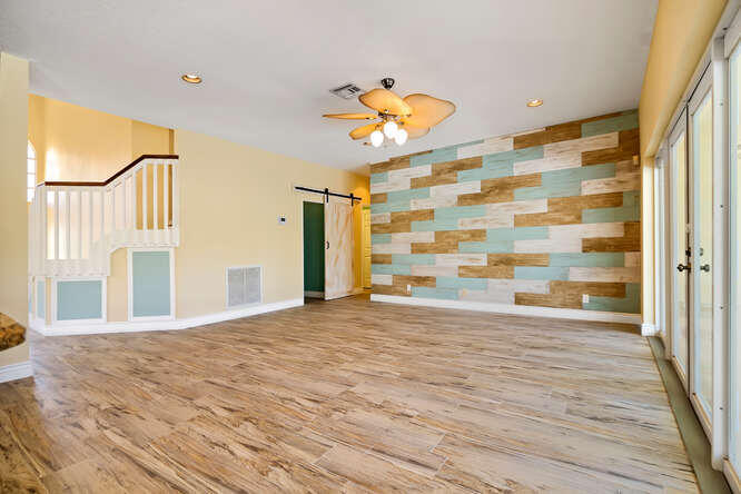 20933 La Plata Court Boca Raton, FL 33428 - Photo 11 of 60 a view of empty room with wooden floor and fan