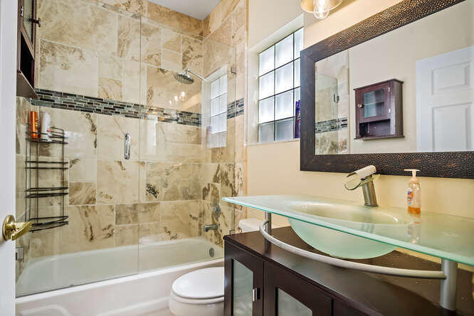 20933 La Plata Court Boca Raton, FL 33428 - Photo 20 of 60 a bathroom with a sink a toilet and a bathtub
