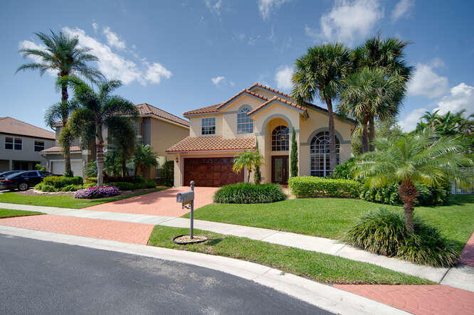20933 La Plata Court Boca Raton, FL 33428 - Photo 2 of 60 a front view of a house with a yard and garage
