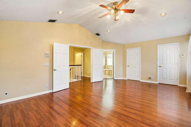 20933 La Plata Court Boca Raton, FL 33428 - Photo 27 of 60 a view of an empty room with window and wooden floor