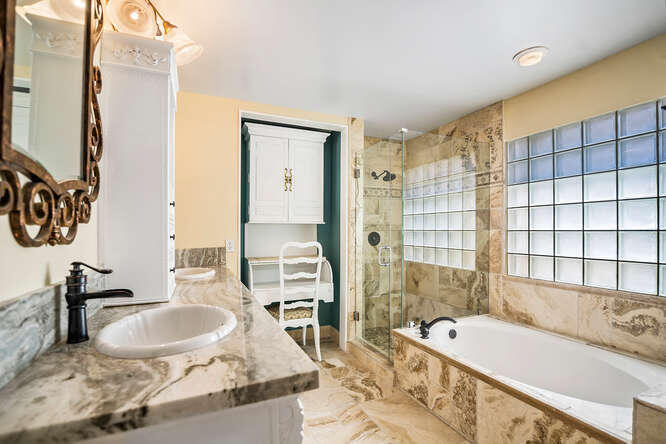 20933 La Plata Court Boca Raton, FL 33428 - Photo 28 of 60 a bathroom with a granite countertop tub sink and mirror