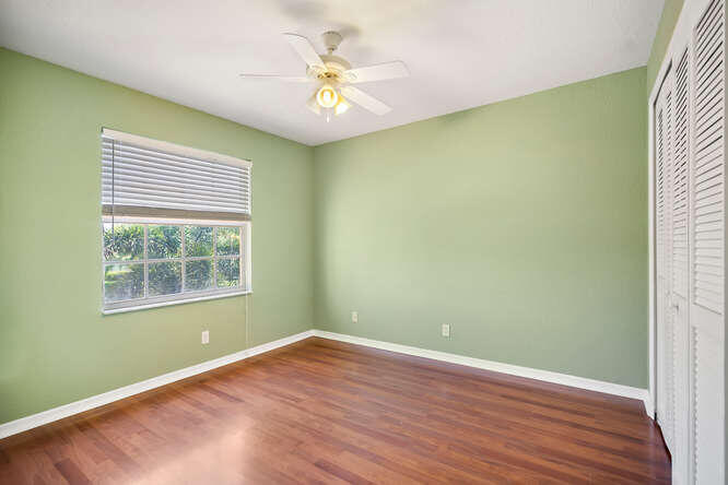 20933 La Plata Court Boca Raton, FL 33428 - Photo 31 of 60 an empty room with a window and wooden floor