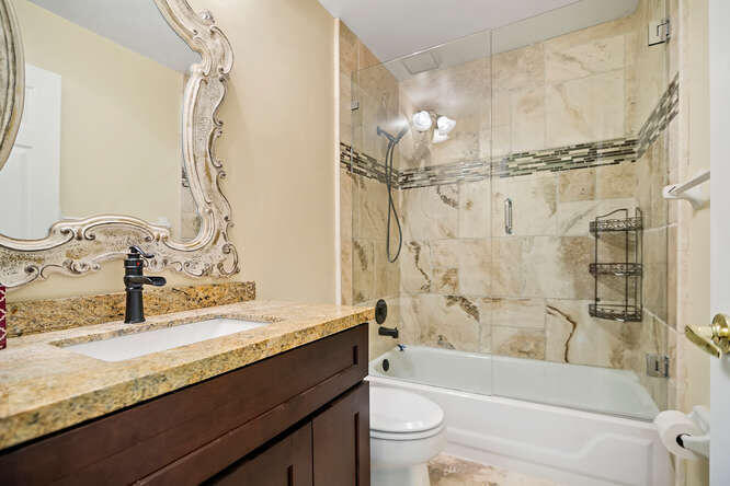 20933 La Plata Court Boca Raton, FL 33428 - Photo 32 of 60 a bathroom with a granite countertop sink a toilet and shower