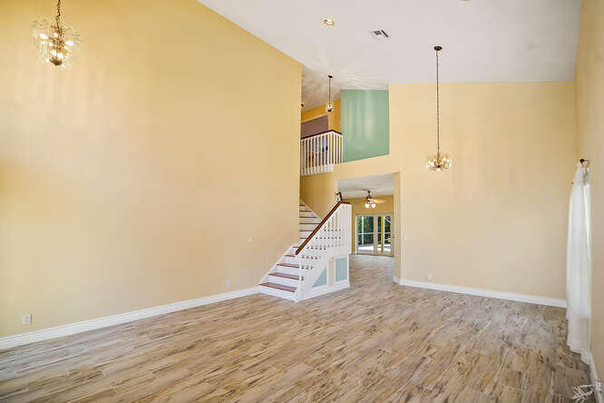 20933 La Plata Court Boca Raton, FL 33428 - Photo 6 of 60 a view of a hallway with wooden floor and a ceiling fan