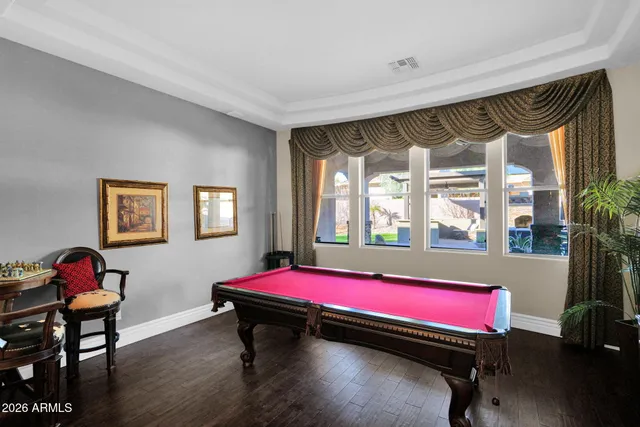 a spacious bedroom with a bed and a chandelier