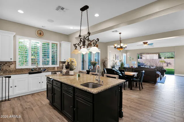 a large kitchen with a table and chairs