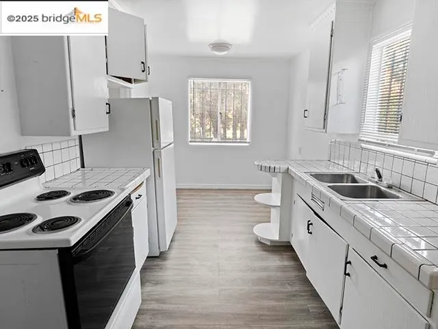 a kitchen with a sink stove and refrigerator