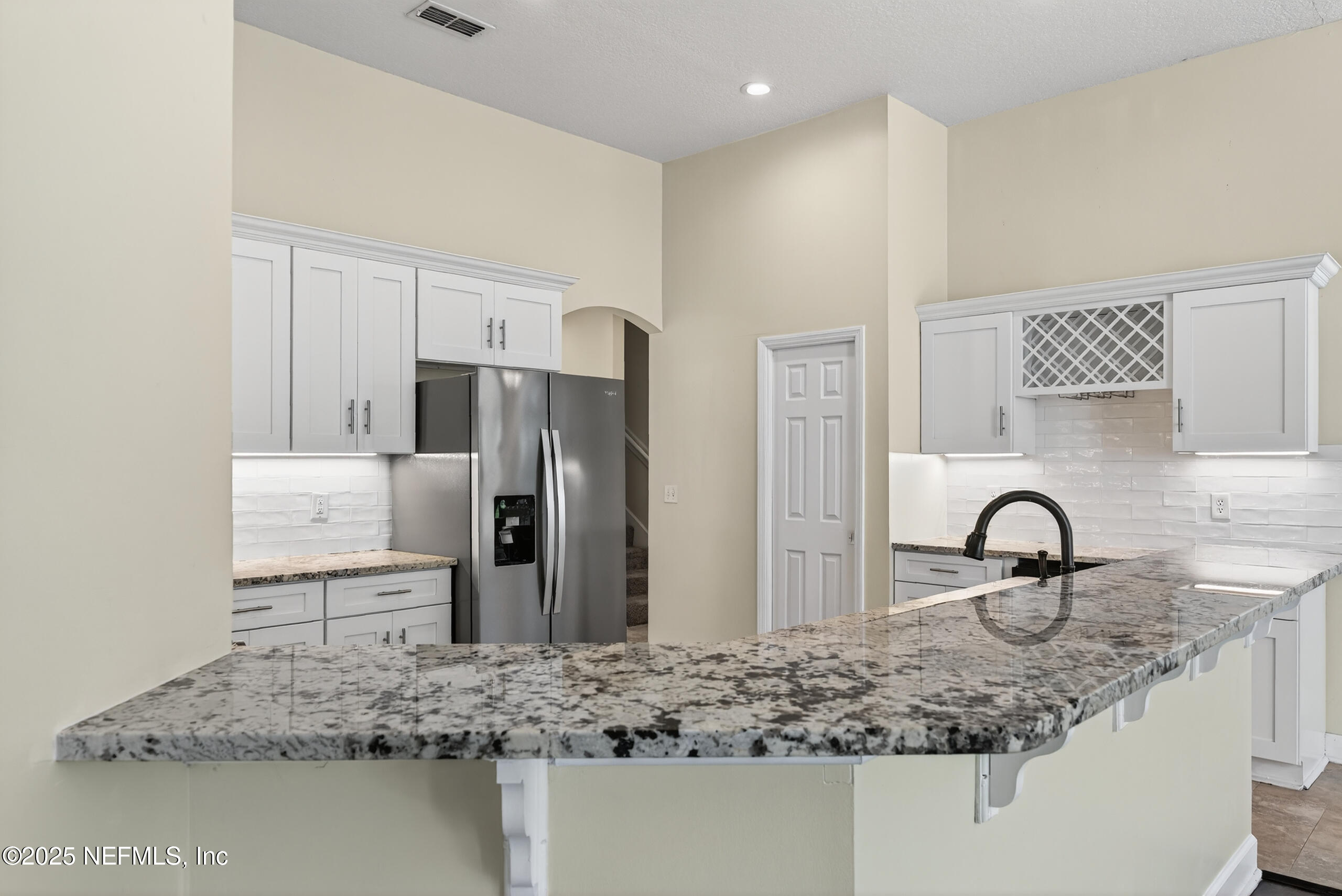 577 Hunters Grove Court Orange Park, FL 32073 - Photo 14 of 40 a kitchen with stainless steel appliances granite countertop a sink and a refrigerator