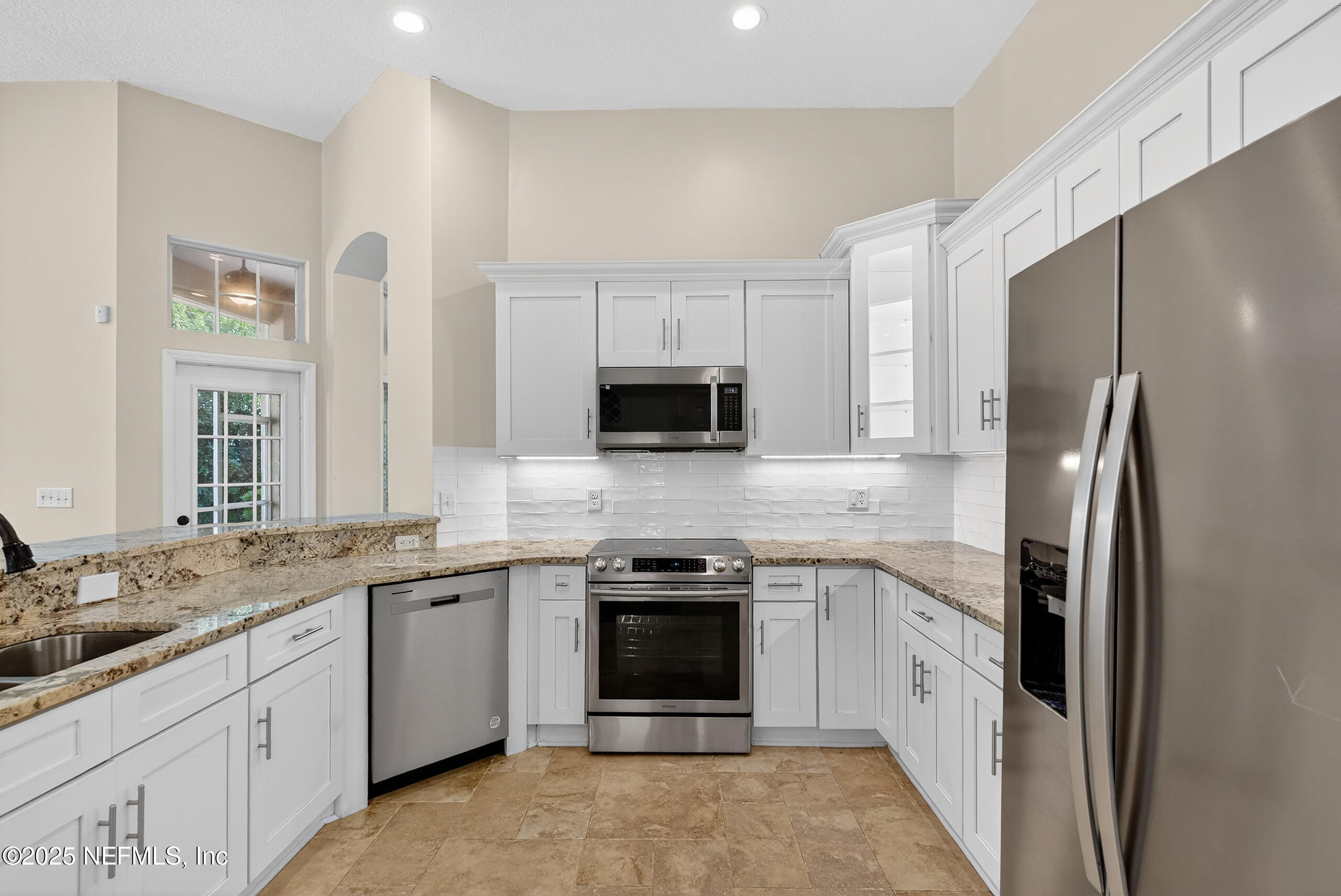 577 Hunters Grove Court Orange Park, FL 32073 - Photo 16 of 40 a kitchen with a sink stove and refrigerator