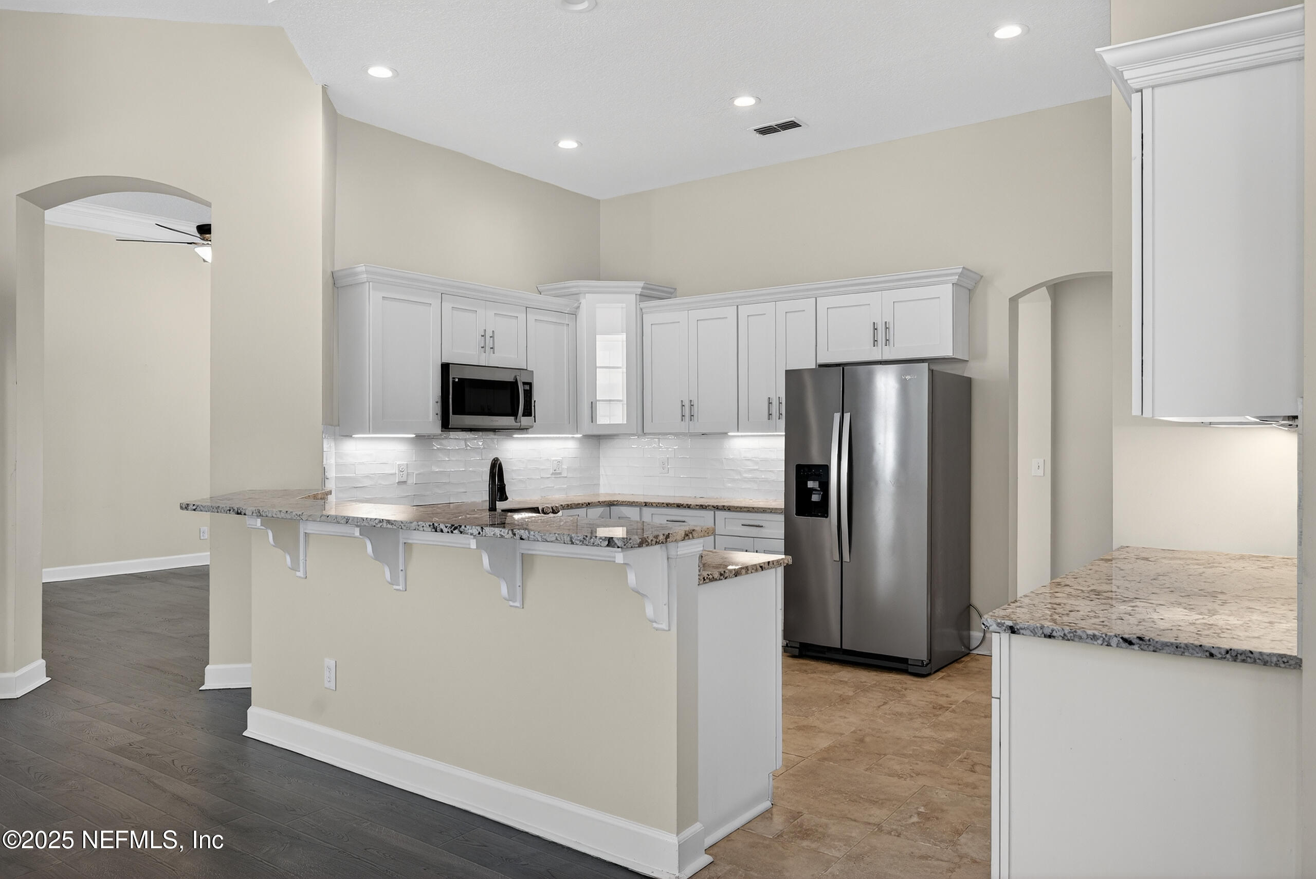 577 Hunters Grove Court Orange Park, FL 32073 - Photo 17 of 40 a kitchen with stainless steel appliances granite countertop a refrigerator a stove and a sink