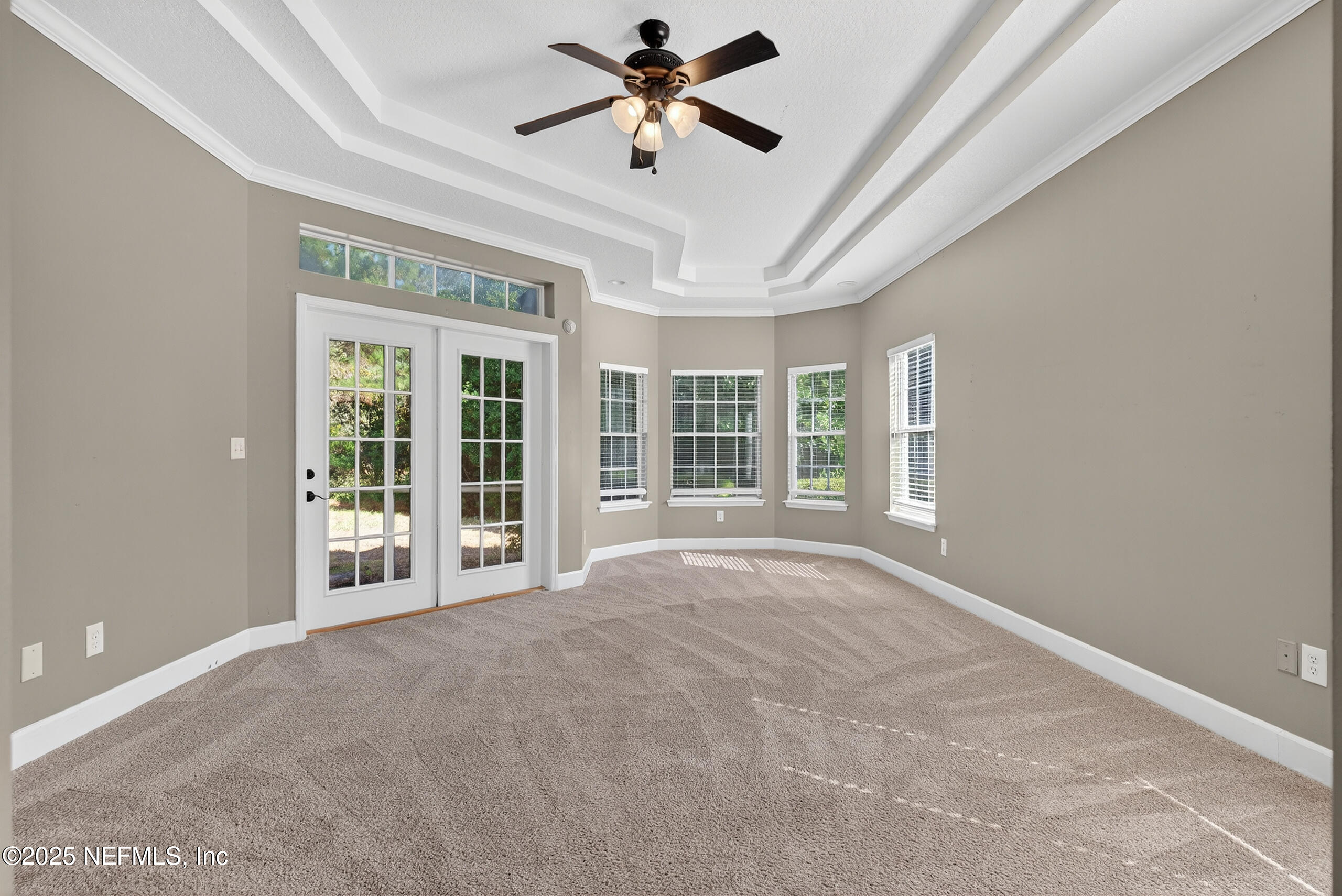 577 Hunters Grove Court Orange Park, FL 32073 - Photo 23 of 40 a view of an empty room with a ceiling fan and windows