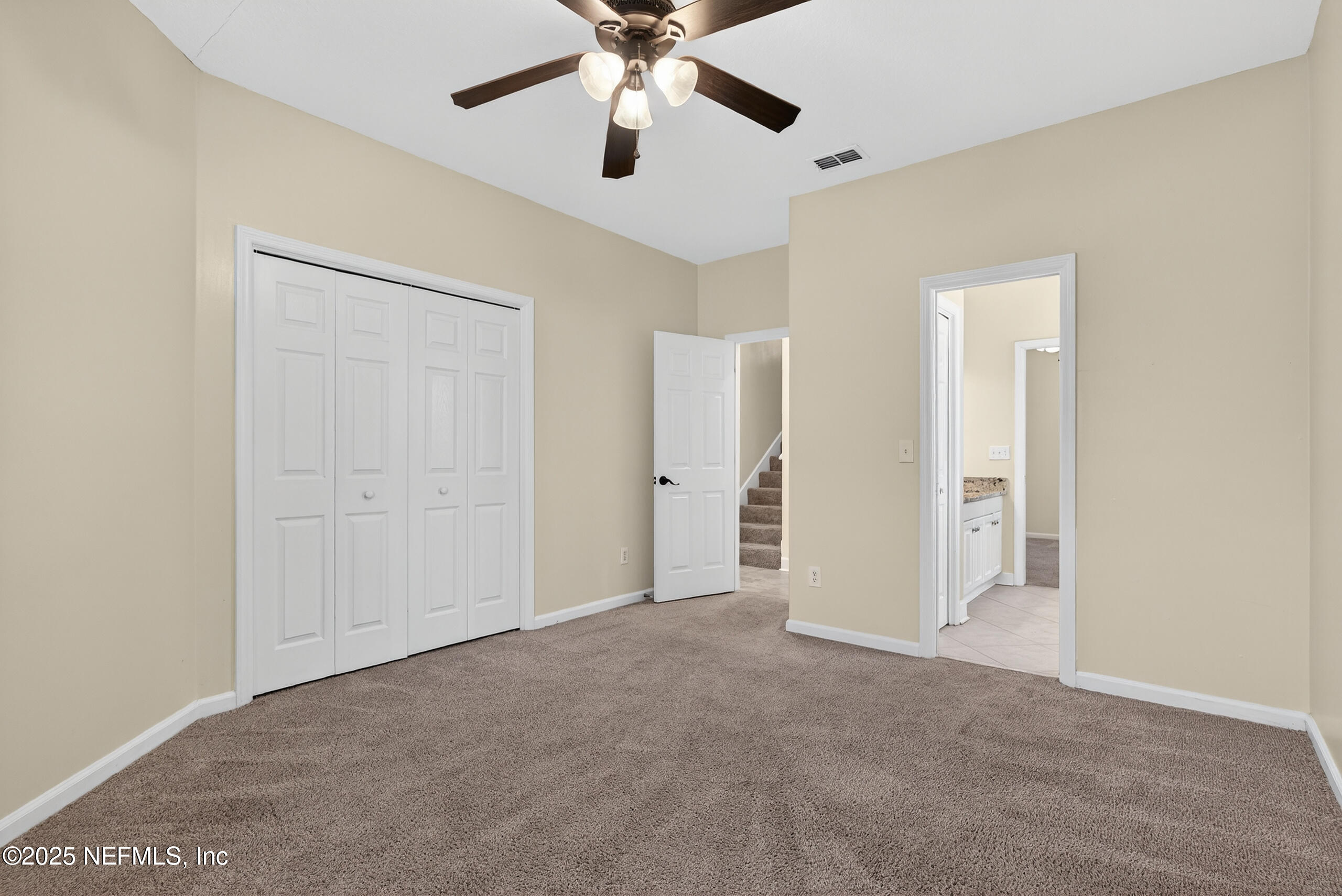 577 Hunters Grove Court Orange Park, FL 32073 - Photo 29 of 40 an empty room with closet and a ceiling fan