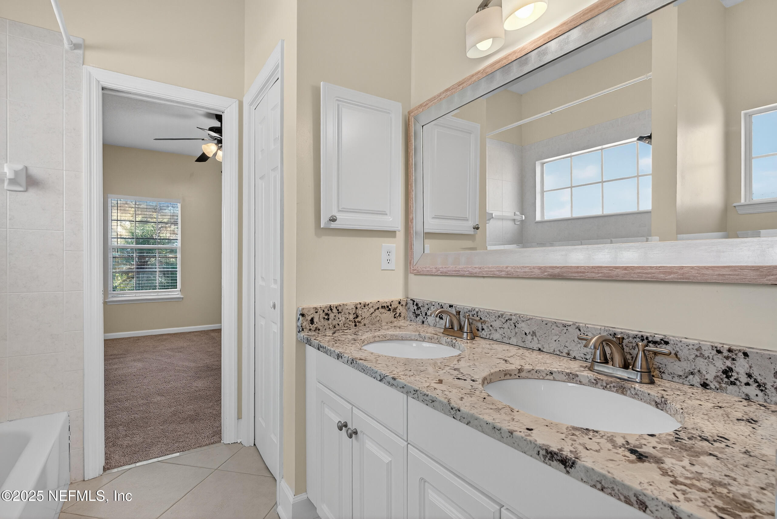 577 Hunters Grove Court Orange Park, FL 32073 - Photo 30 of 40 a bathroom with a granite countertop sink and a mirror