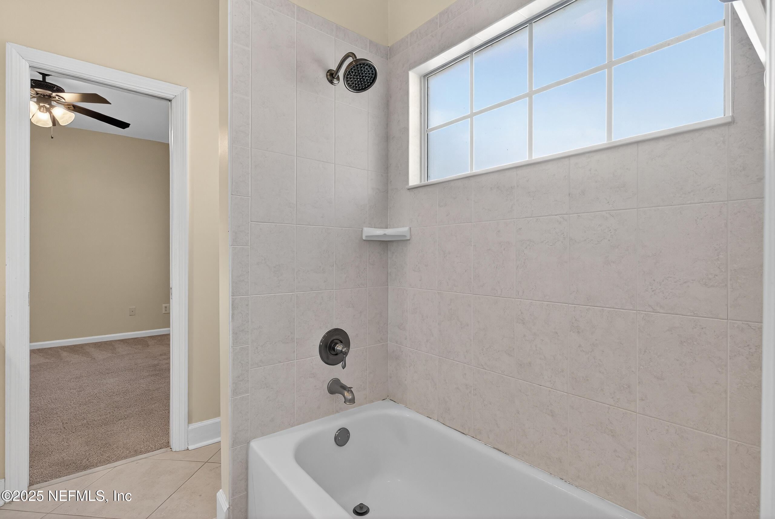 577 Hunters Grove Court Orange Park, FL 32073 - Photo 31 of 40 a bathroom with a tub and shower