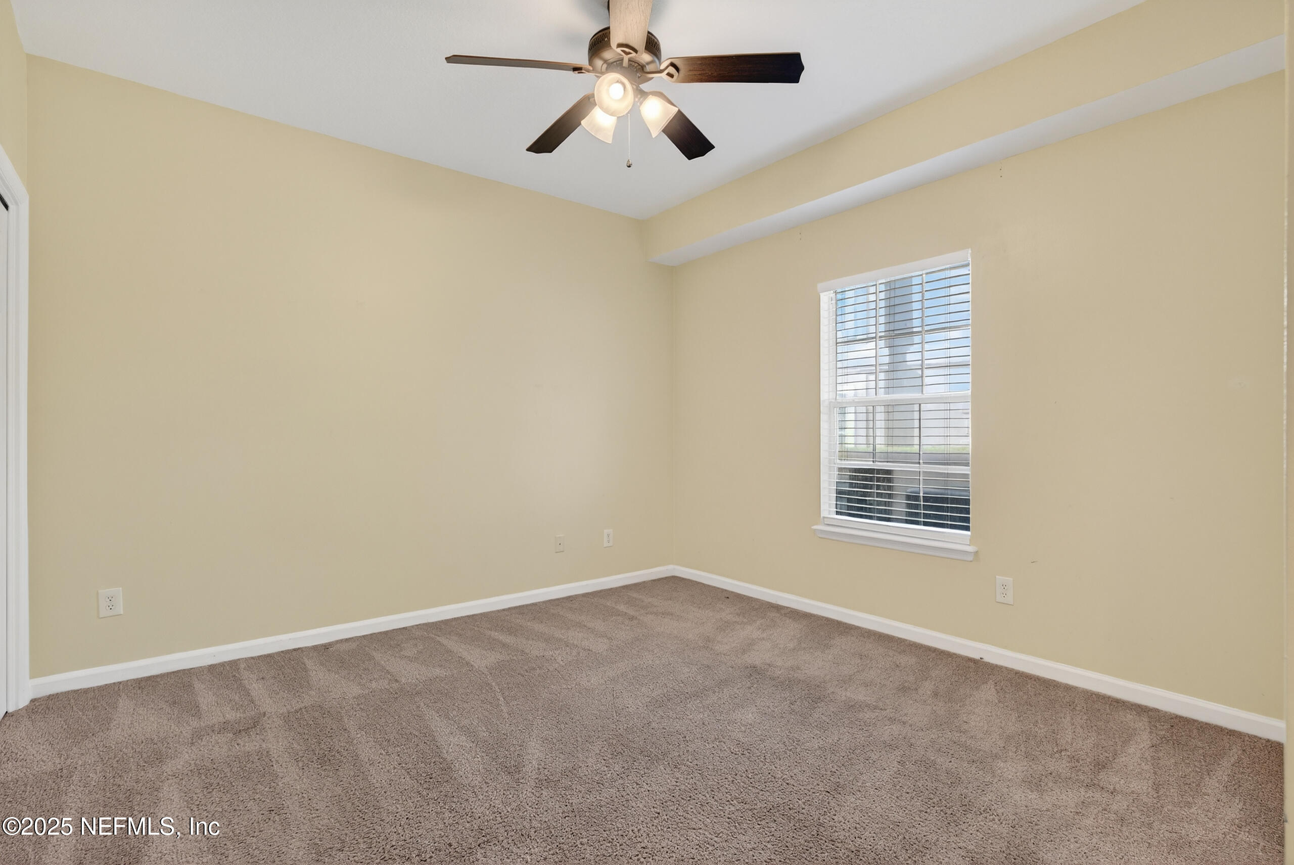 577 Hunters Grove Court Orange Park, FL 32073 - Photo 32 of 40 an empty room with windows and fan