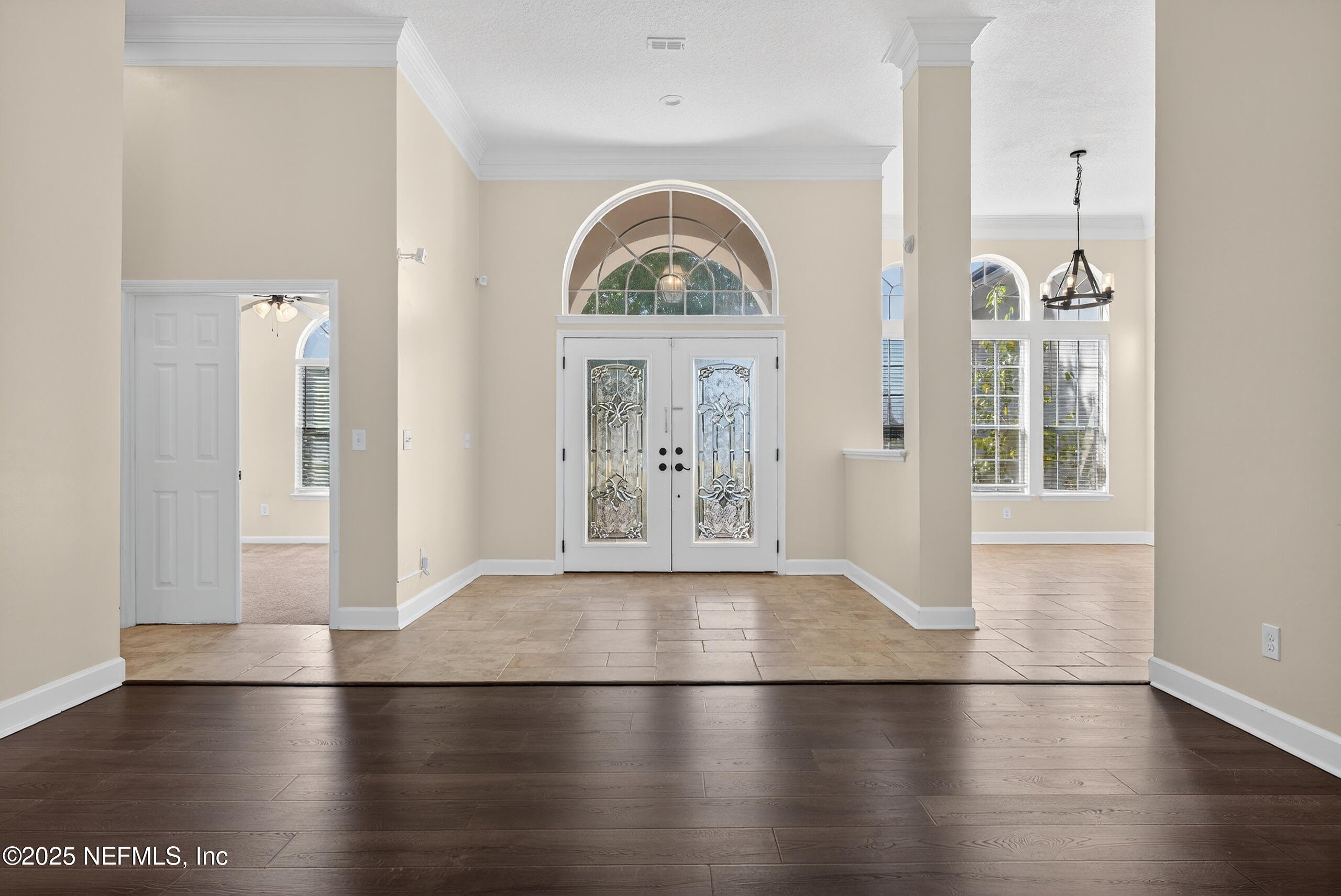 577 Hunters Grove Court Orange Park, FL 32073 - Photo 7 of 40 an empty room with wooden floor mirror and windows