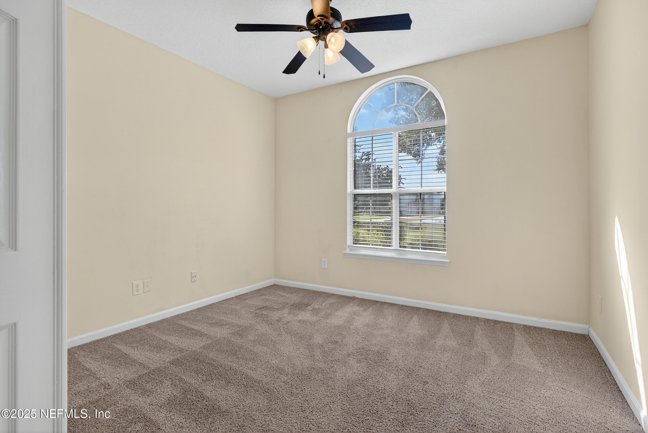 577 Hunters Grove Court Orange Park, FL 32073 - Photo 10 of 40 an empty room with chandelier fan and windows