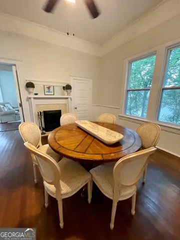 a dining room with furniture and wooden floor