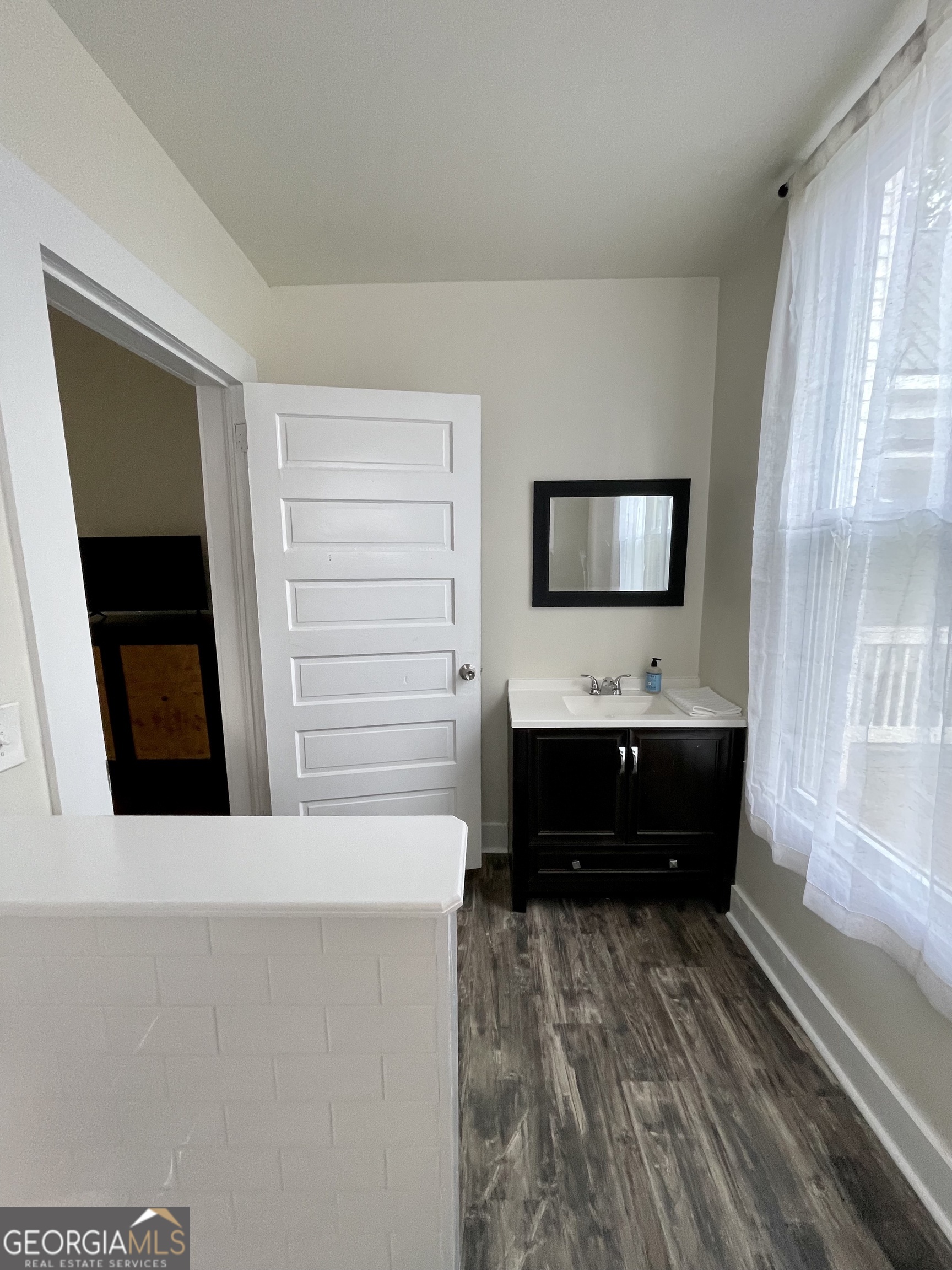 400 West Gordon Street Thomaston, GA 30286 - Photo 20 of 43 a living room with a flat screen tv and a fireplace