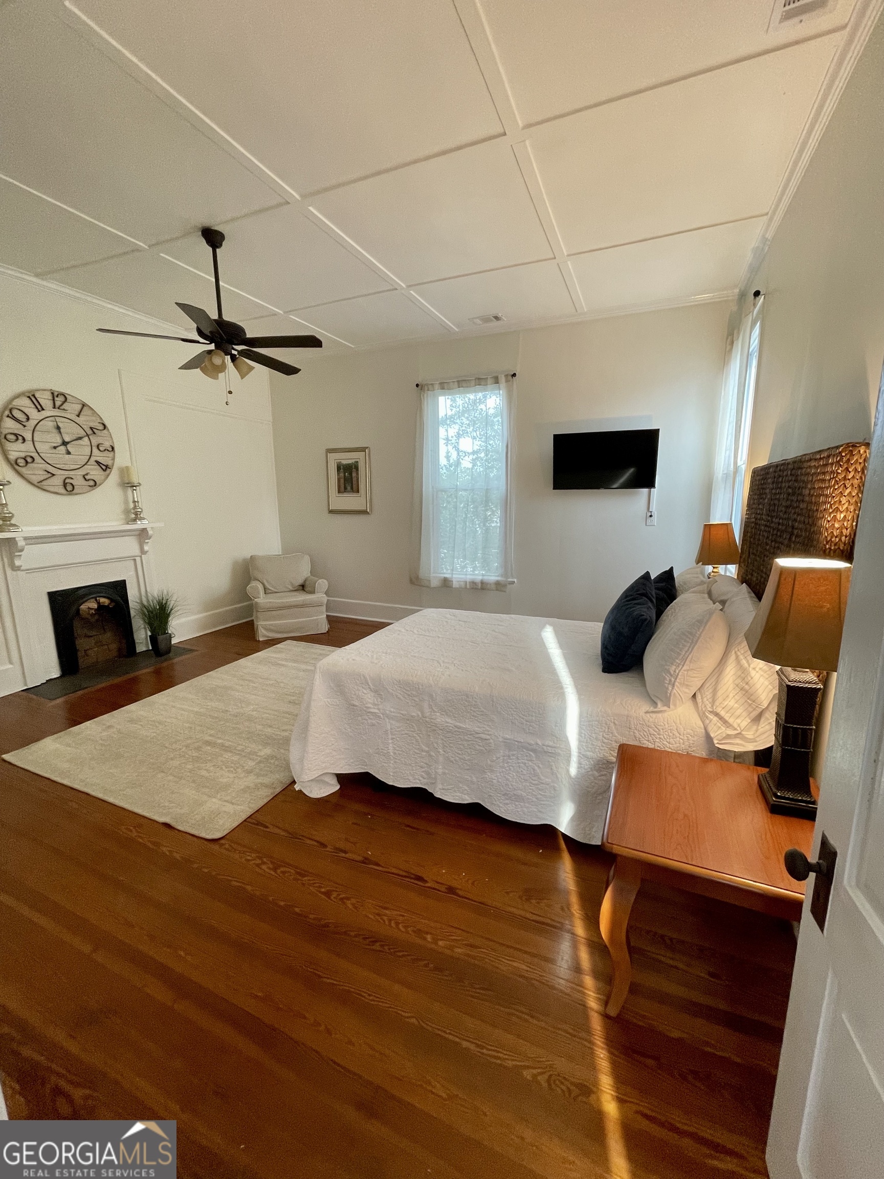 400 West Gordon Street Thomaston, GA 30286 - Photo 25 of 43 a bedroom with a bed a ceiling fan and a wooden floor