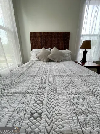 a bedroom with bed and window