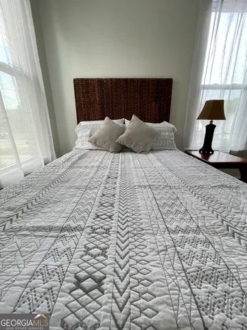 a bedroom with bed and window