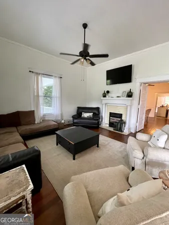 a living room with furniture a fireplace and a flat screen tv