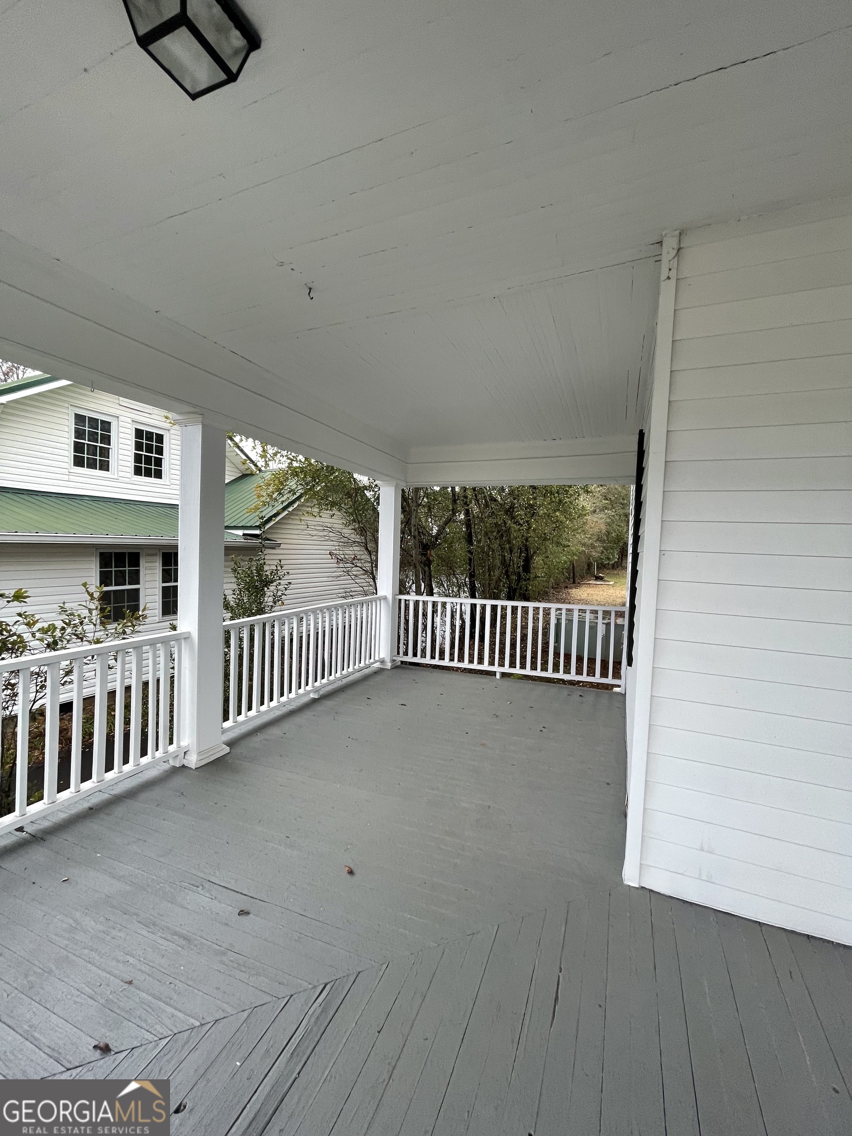 400 West Gordon Street Thomaston, GA 30286 - Photo 35 of 43 a view of a porch with a floor to ceiling window and stairs