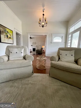 a living room with furniture and a chandelier