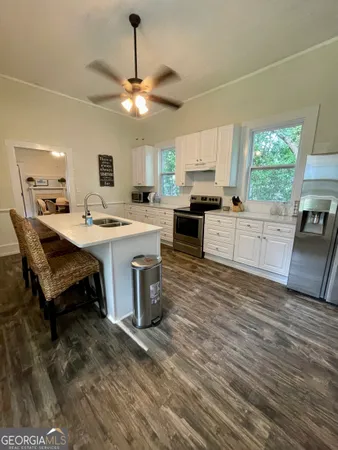 a kitchen with a stove a sink and a refrigerator