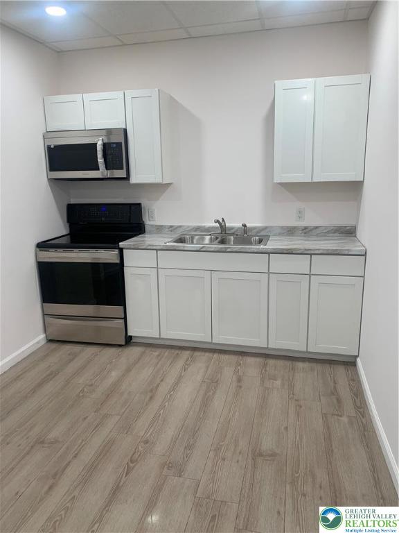 1119 Hamilton Street, Unit 1 REAR Allentown, PA 18101 - Photo 3 of 7 a kitchen with stainless steel appliances granite countertop a stove a sink and a microwave