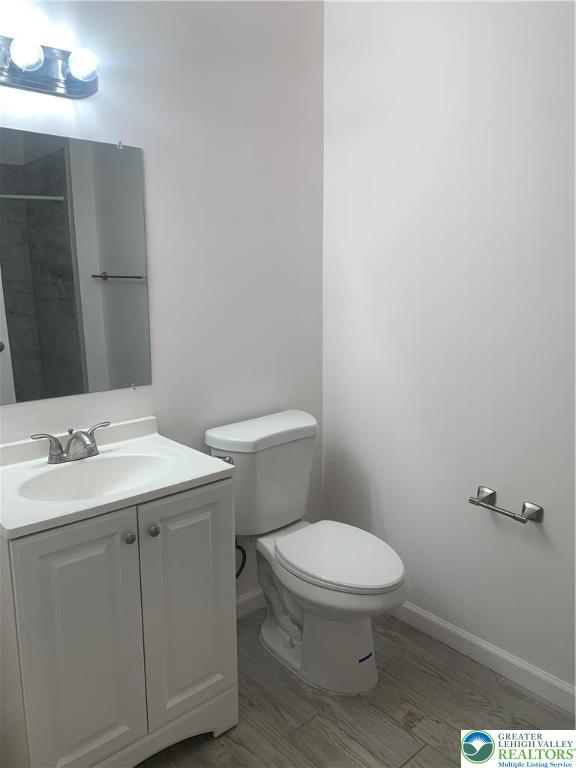 1119 Hamilton Street, Unit 1 REAR Allentown, PA 18101 - Photo 7 of 7 a bathroom with a sink a toilet and a mirror