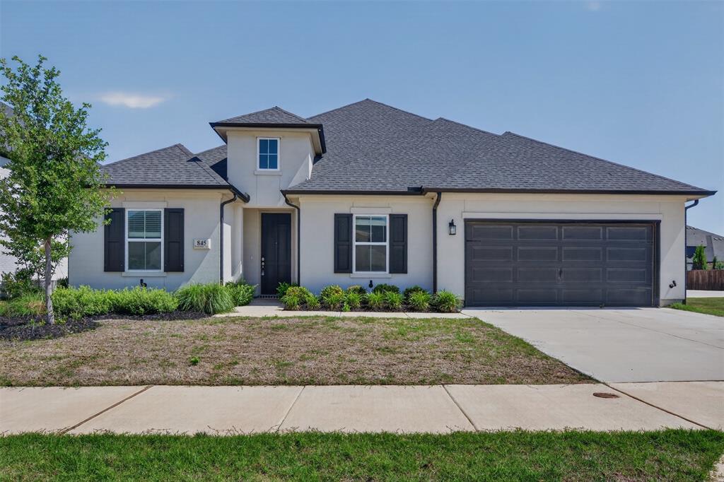 845 Ranchland Road Justin, TX 76247 - Photo 2 of 22 a front view of a house with garden