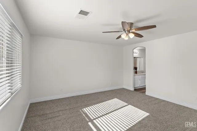 a view of an empty room and a window