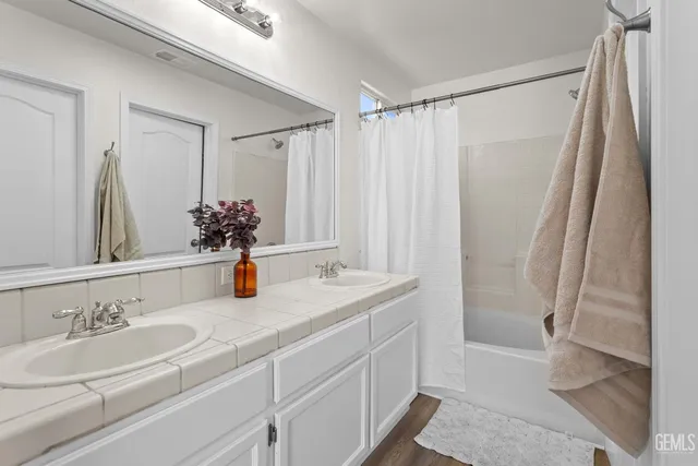 a bathroom with a double vanity sink and a mirror