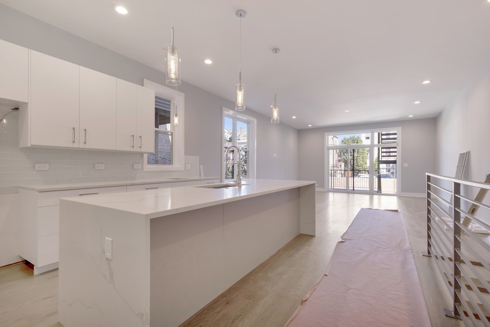 1732 West 19th Street, Unit 1 Chicago, IL 60608 - Photo 5 of 17 a large kitchen with stainless steel appliances a large counter top a stove and a refrigerator