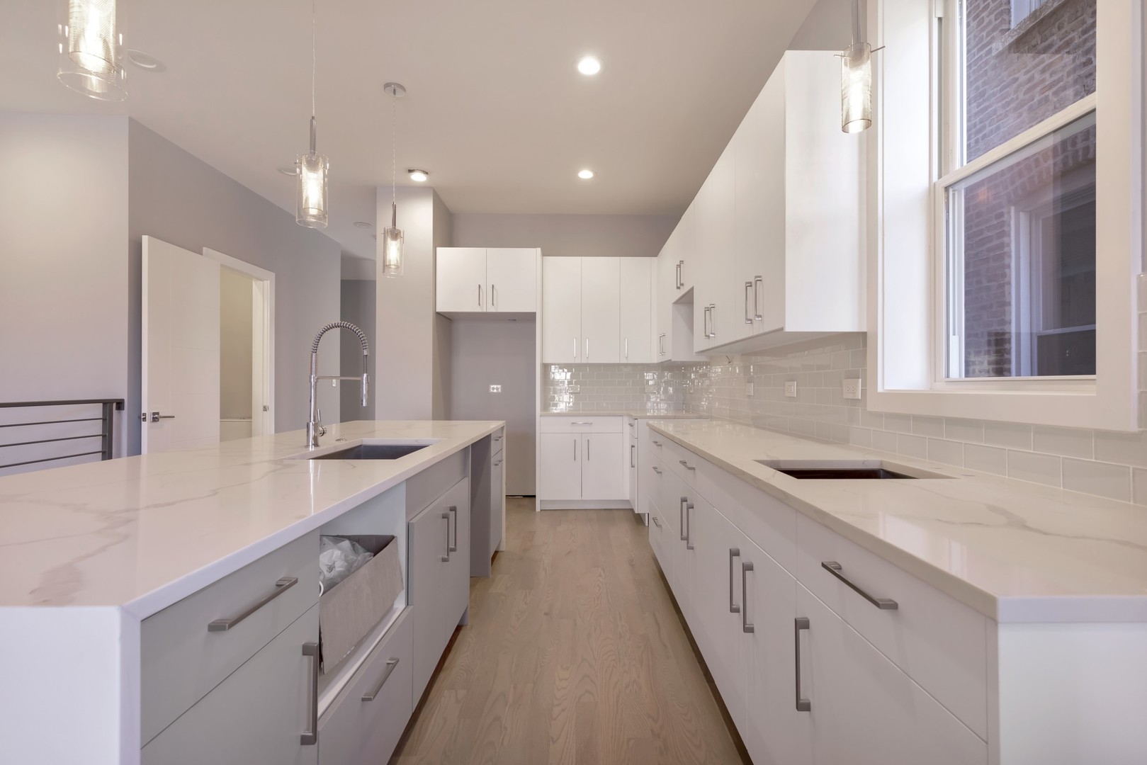 1732 West 19th Street, Unit 1 Chicago, IL 60608 - Photo 7 of 17 a view of a kitchen with kitchen island a sink stainless steel appliances and a window