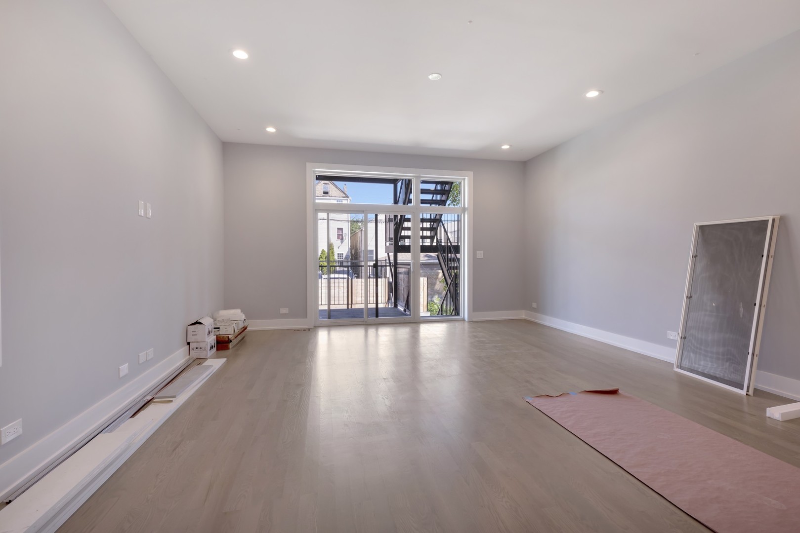 1732 West 19th Street, Unit 1 Chicago, IL 60608 - Photo 8 of 17 wooden floor in an empty room with a window