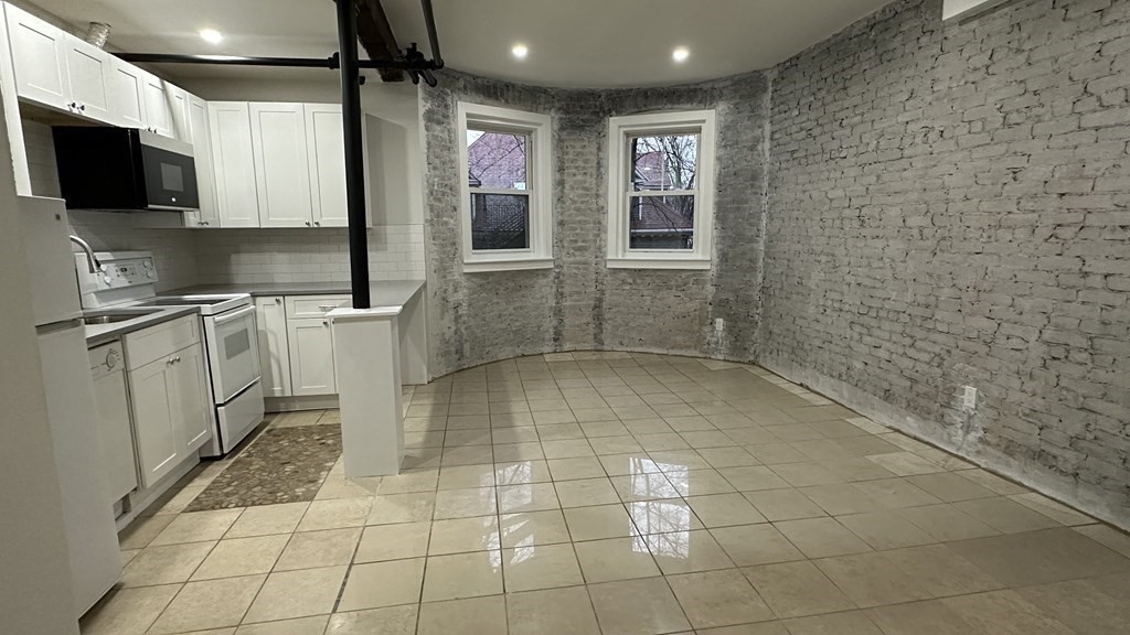 147 Winthrop Road, Unit 2 Brookline, MA 02445 - Photo 16 of 19 a bathroom with a sink a large mirror and a shower
