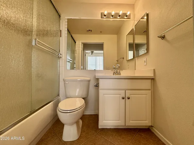 a bathroom with a toilet sink and a mirror