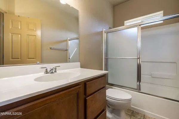 a bathroom with a sink toilet vanity and shower