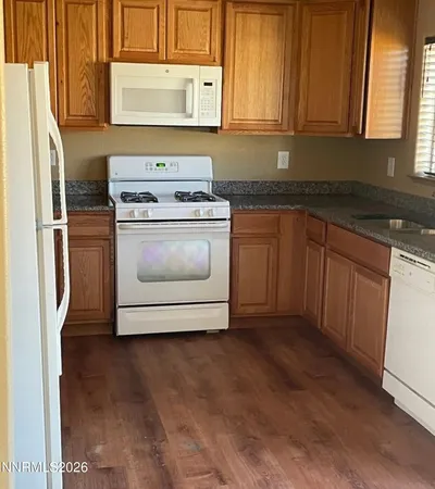 a kitchen with stainless steel appliances granite countertop a stove a refrigerator and a microwave