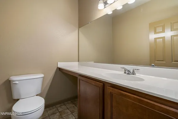a bathroom with a sink a toilet and mirror