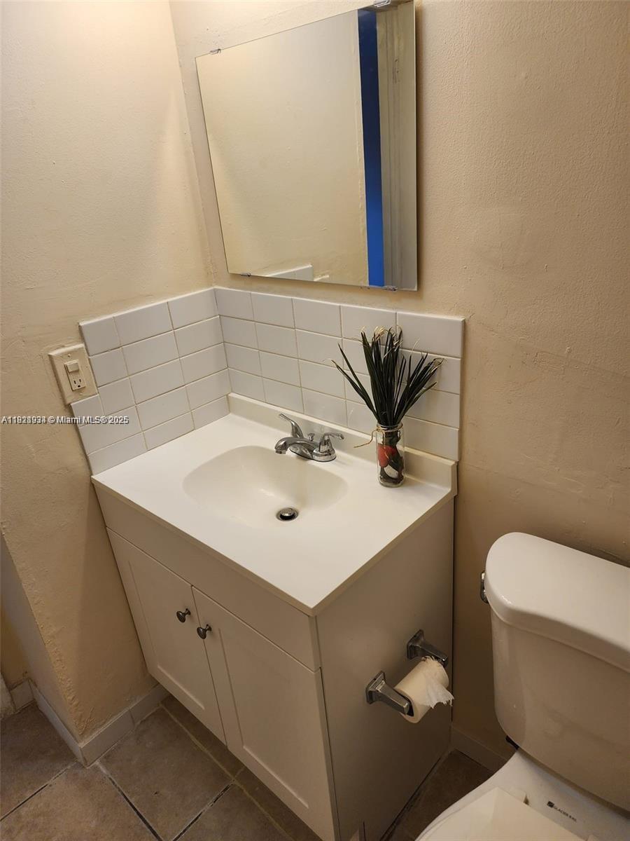 241 Southeast 9th Avenue, Unit 110 Pompano Beach, FL 33060 - Photo 5 of 15 a bathroom with a sink mirror and toilet