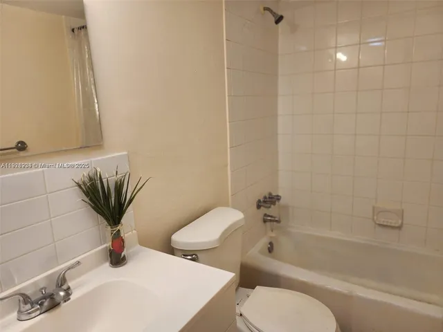 a bathroom with a toilet sink and bathtub