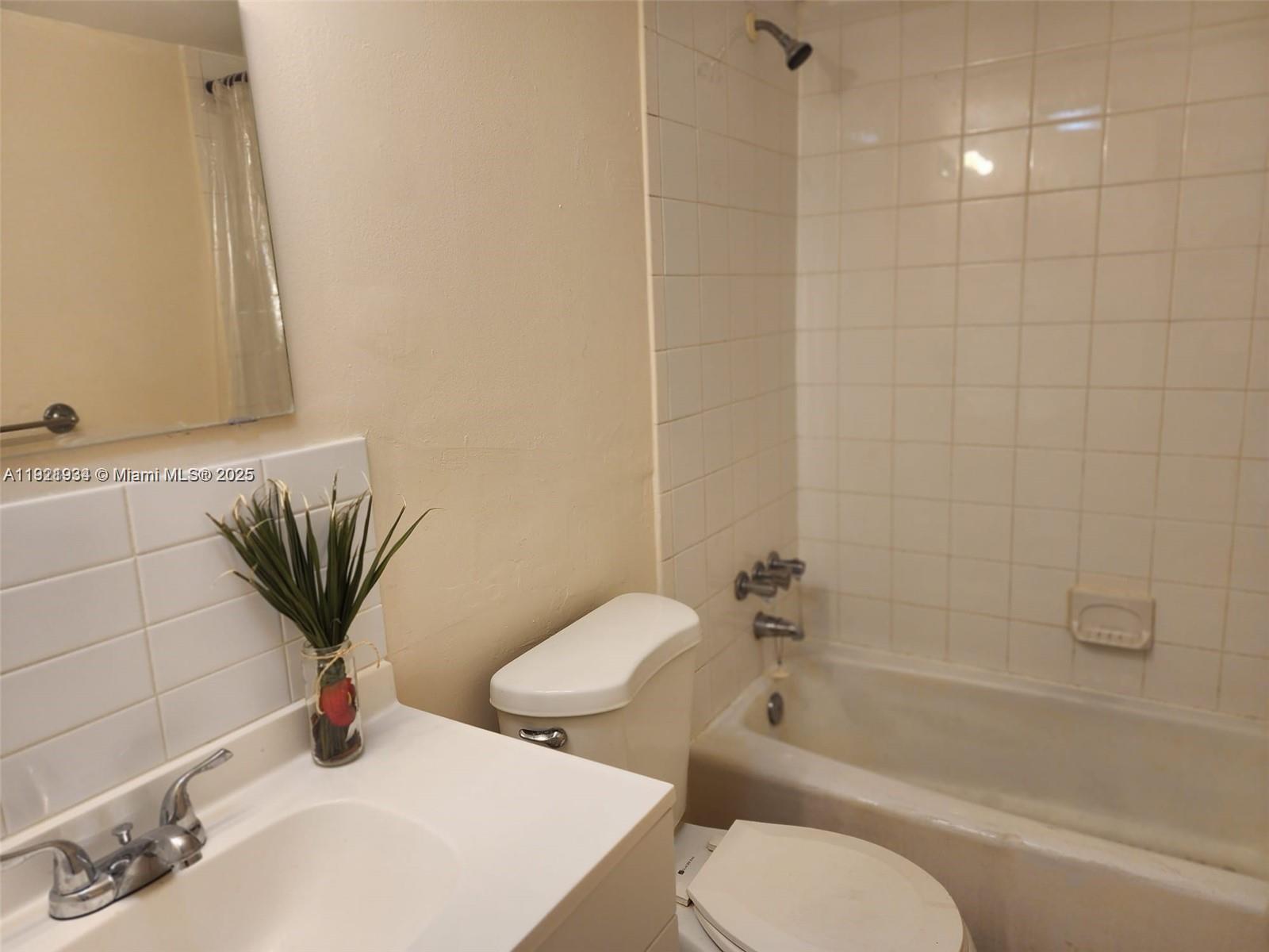 241 Southeast 9th Avenue, Unit 110 Pompano Beach, FL 33060 - Photo 9 of 15 a bathroom with a toilet sink and bathtub