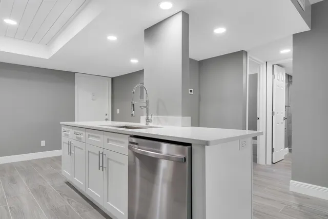 a kitchen with a sink and a refrigerator