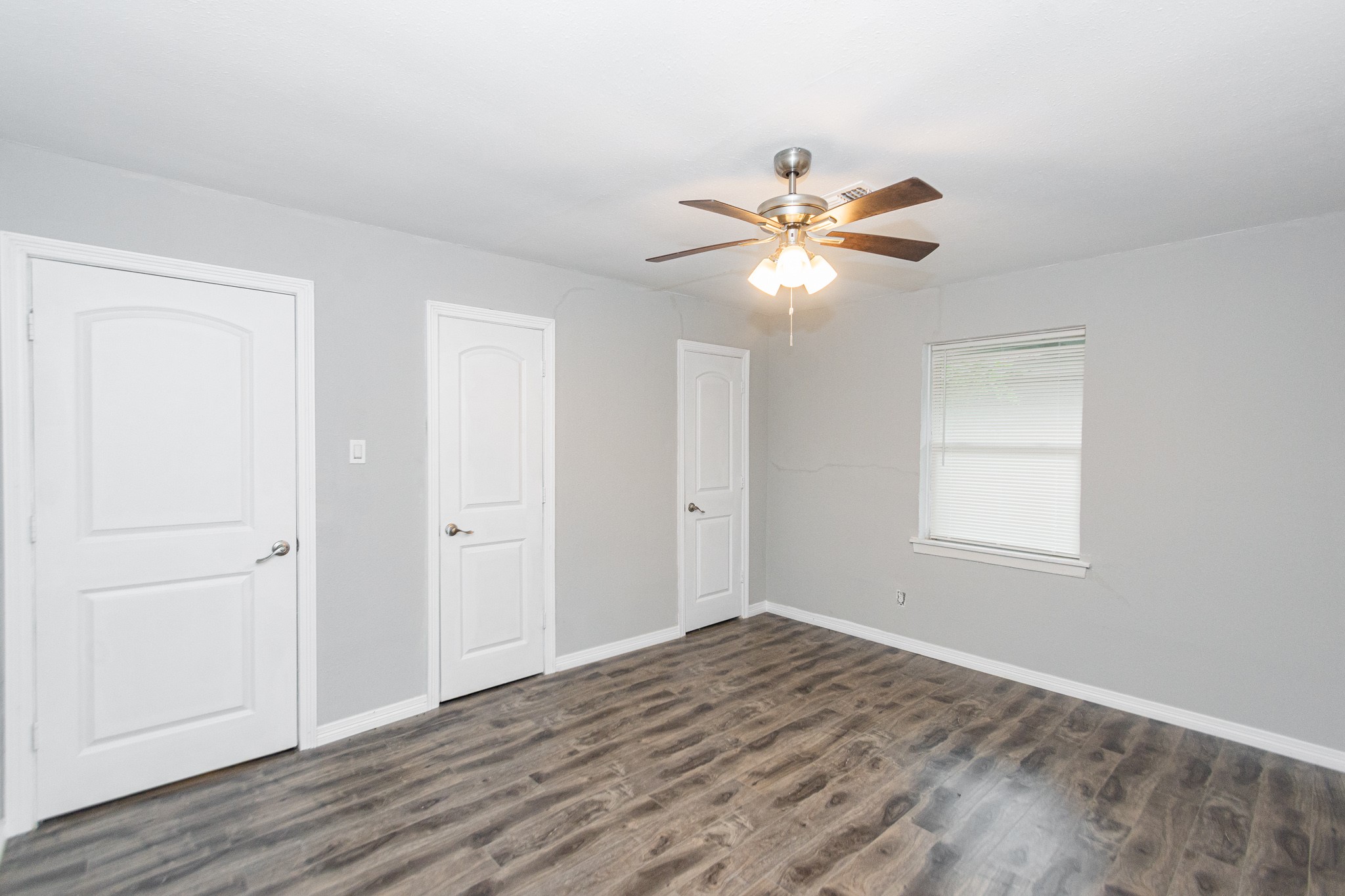 2002 Nottingham Street Pasadena, TX 77502 - Photo 11 of 33 wooden floor in an empty room with a window